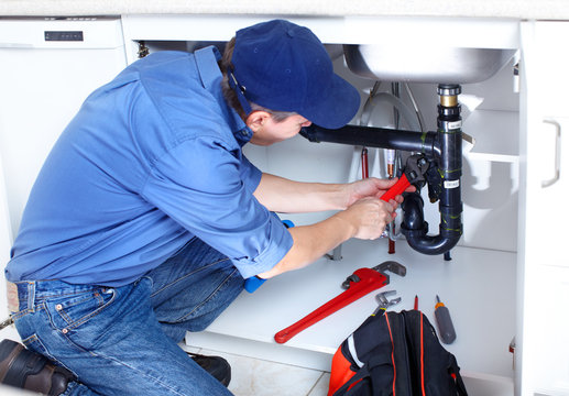 Plumber working in a crawl space